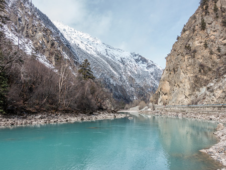the Brahmaputra cross through the tibetan plateau snow mountain in Bomi, Tibet China.の写真素材