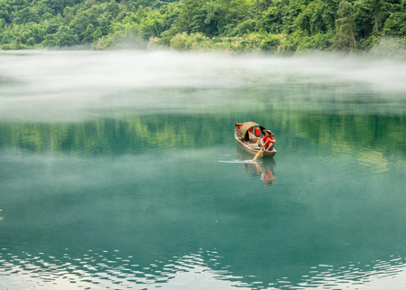 A fisherman in the famous Misty Small Dongjiang (east river) in Chenzhou, Hunan province of China.の写真素材