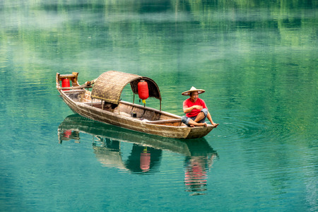 A fisherman in the famous Misty Small Dongjiang (east river) in Chenzhou, Hunan province of China.の写真素材