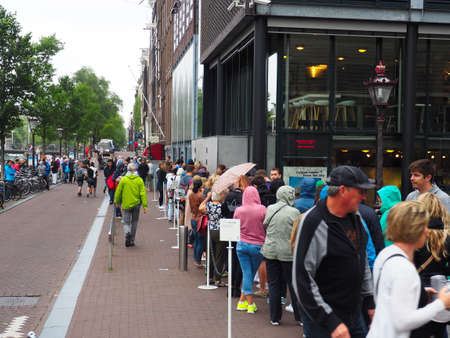 Amsterdam, The Netherlands, Summer 2015. Front portion of a logn waiting line for the famous anne...