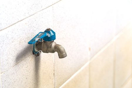 old faucet on concrete wall, save the water conceptの写真素材