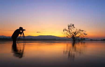 silhouette photographer taken alone tree in the lake,の写真素材