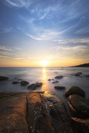 sea rock and sunset の写真素材