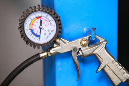 Close-up of manometer hanged in a mechanic shop
