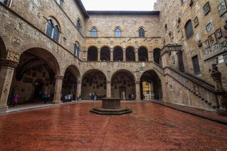 Florence, Italy - 2019, April 7: Tourists pass through the courtyard in the National Museum of Bargello, a former barracks and prison, now an art museum.のeditorial素材