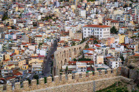 Kavala, Greece - December 1, 2019: Aerial view with the buildings in the city of Kavala in northern Greece, ancient aqueduct Kamares, and medieval city wallのeditorial素材