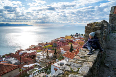 Little girl enjoys the view from the fortress of the old city of Kavala to the Aegean islands, northern Greeceのeditorial素材
