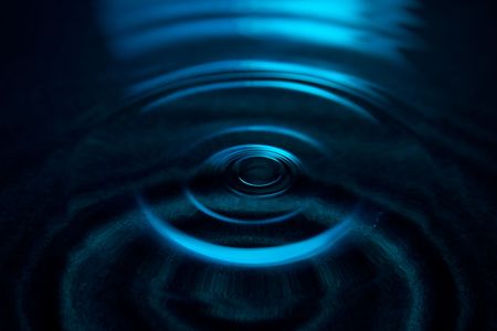 Wave concentric pattern on water surface. On location blue light (no photoshop)の写真素材