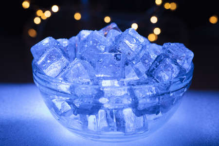 Bowl of wet ice with garlands in the backgroundの写真素材