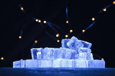 Ice cubes pile with warm lights abstract backgroundの写真素材