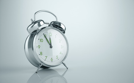 Vintage metal reflective alarm clock background. It's ten to twelve, clock tickingの写真素材