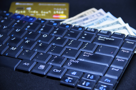 Computer keyboard with dollars and cardの写真素材
