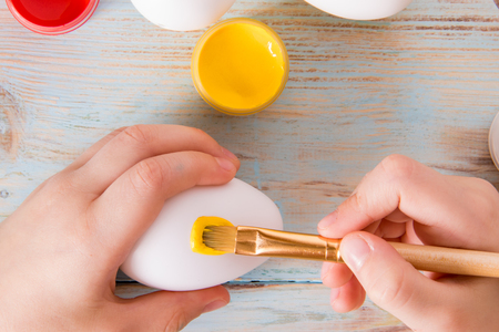 Preparation for Easter, little boy hands painted Easter eggsの写真素材