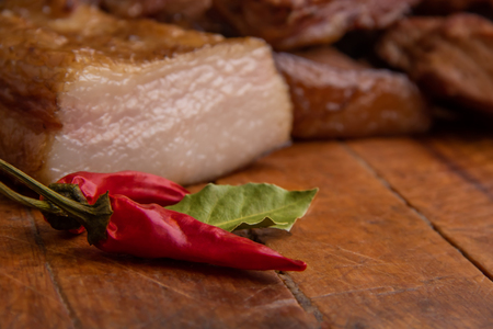 Smoked pork ribs and meat on wooden board with red paper and copyspaceの写真素材