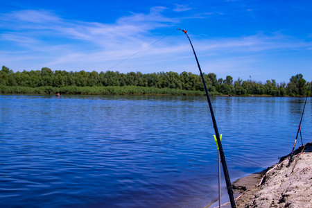 Fishing on the feeder on the shore of a beautiful riverの写真素材