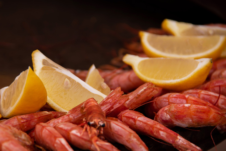 Testy boiled ocean shrimps with lemon slicesの写真素材