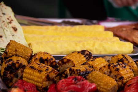 Grilled corn grilled on fire with red pepper