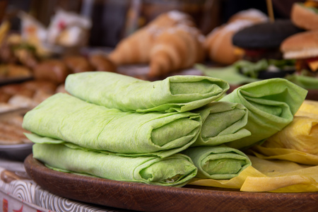 Shawrma arabic food in pita bread is sprinkled with greens and vegetables at the festival of street foodの写真素材