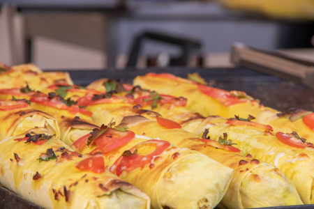 Shawrma in pita bread is sprinkled with greens and vegetables at the festival of street food with copyspaceの写真素材