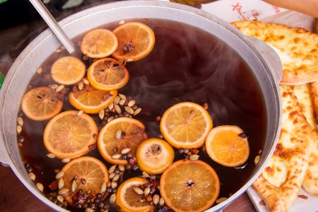Large casserole with mulled wine chopped oranges and spices street food fastivalの写真素材