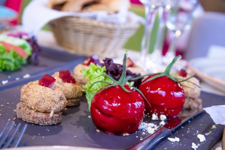 Molecular cuisine Paste in the form of red tomato with herbsの写真素材