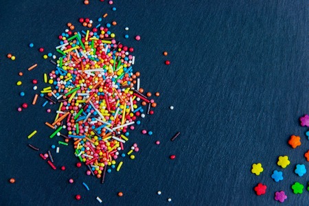 Multicolor candies on stone dark blue background. Top view with copyspaceの写真素材