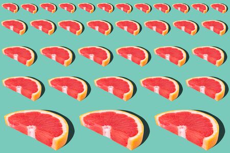 Tasty ripe grapefruit slices on blue background, flat layの写真素材