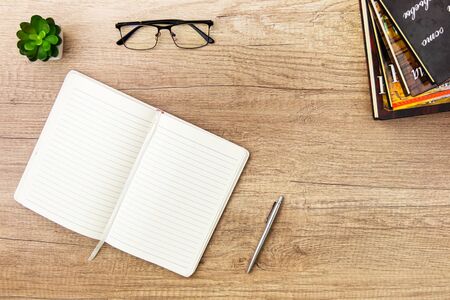 Workplace styled flat lay, learning concept. Notebook, pen, succulent and stack of books on marble table. Copyspaceの写真素材