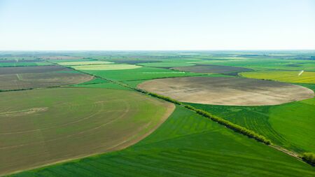 Aerial view over rural area with rape fields and green areas