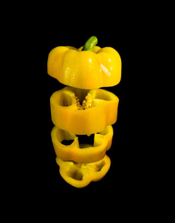 Nutrition and diet food picture with sliced fresh sweet pepper on black background.の写真素材