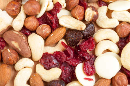 Above close up shot of an assortment of nuts a dried furit laid out on a wooden tableの写真素材
