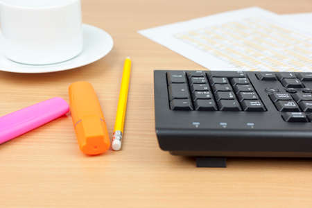 Financial accountants desktop showing a computer keyboard, spread sheets and pensの写真素材