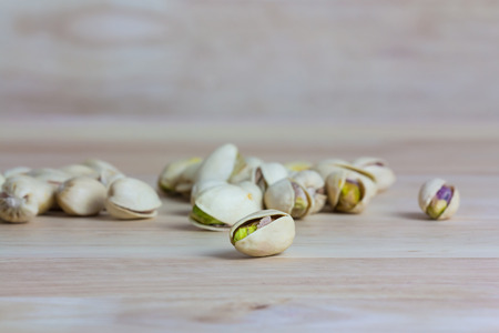 Close up pistachios on wooden backgroundの写真素材