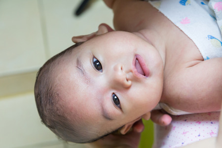 Close up  baby bathing on mothers handsの写真素材