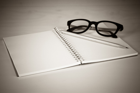 Notebook with a pencil and eye glasses, Vintage effect