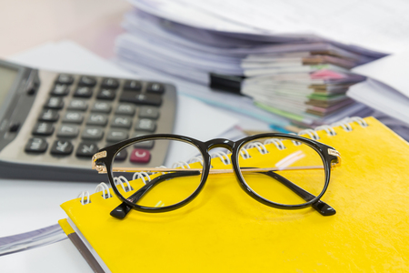 Eye glasses and Stack of business papersの写真素材