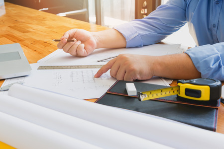 Architects concept, Architects working with blueprints in the office