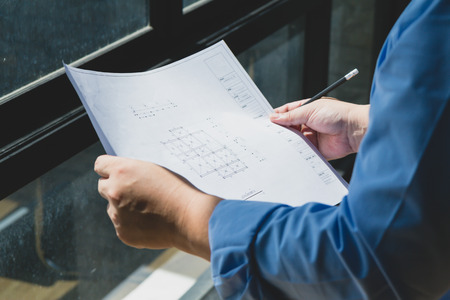 Architects concept, Architects working with blueprints in the office