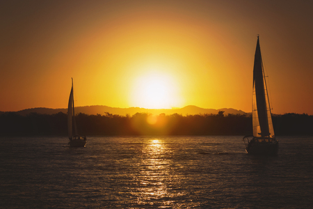 Sailing yacht against sunset