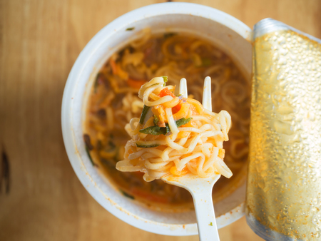 Noodles with a Plastic Fork on wooden tableの写真素材