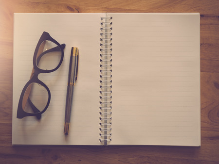 Education and office concept. Pen notebook and eyeglasses, Vintage effectの写真素材