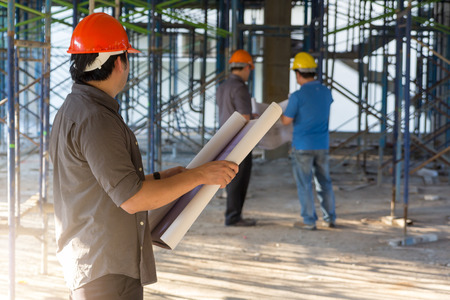 Construction concepts, Engineer and Architect working at Construction Site with blueprint