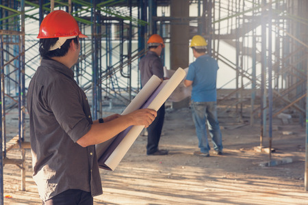 Construction concepts, Engineer and Architect working at Construction Site with blueprint, Vintage Effectの写真素材