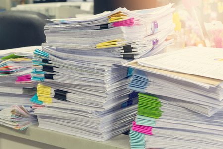 Pile of unfinished documents on office desk, Stack of business paperの写真素材