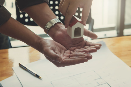 Engineer and Architect concept, Engineer Architects office team working with blueprints and house model, Vintage Effectの写真素材