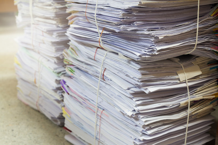 Business and finance concept of office working, Pile of unfinished documents on office desk, Stack of business paperの写真素材