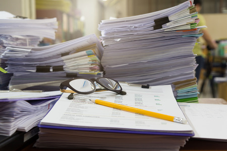 Business and finance concept of office working, Pile of unfinished documents on office desk, Stack...