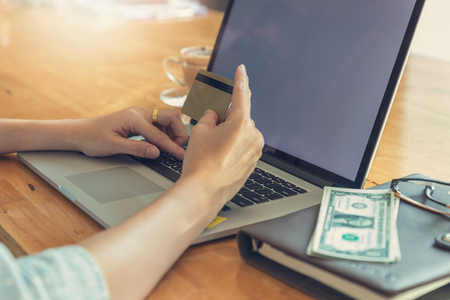 Online shopping concept, Woman shopping using laptop pc and credit cardの写真素材