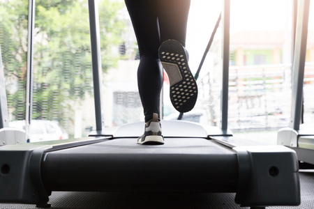 Fitness woman running on running machine at gym, Fat Burning Cardio Workoutの写真素材
