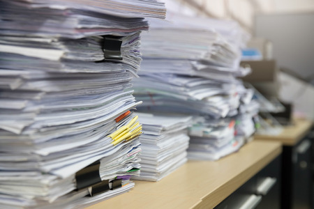 Business and finance concept of office working, Pile of unfinished documents on office desk, Stack of business paperの写真素材